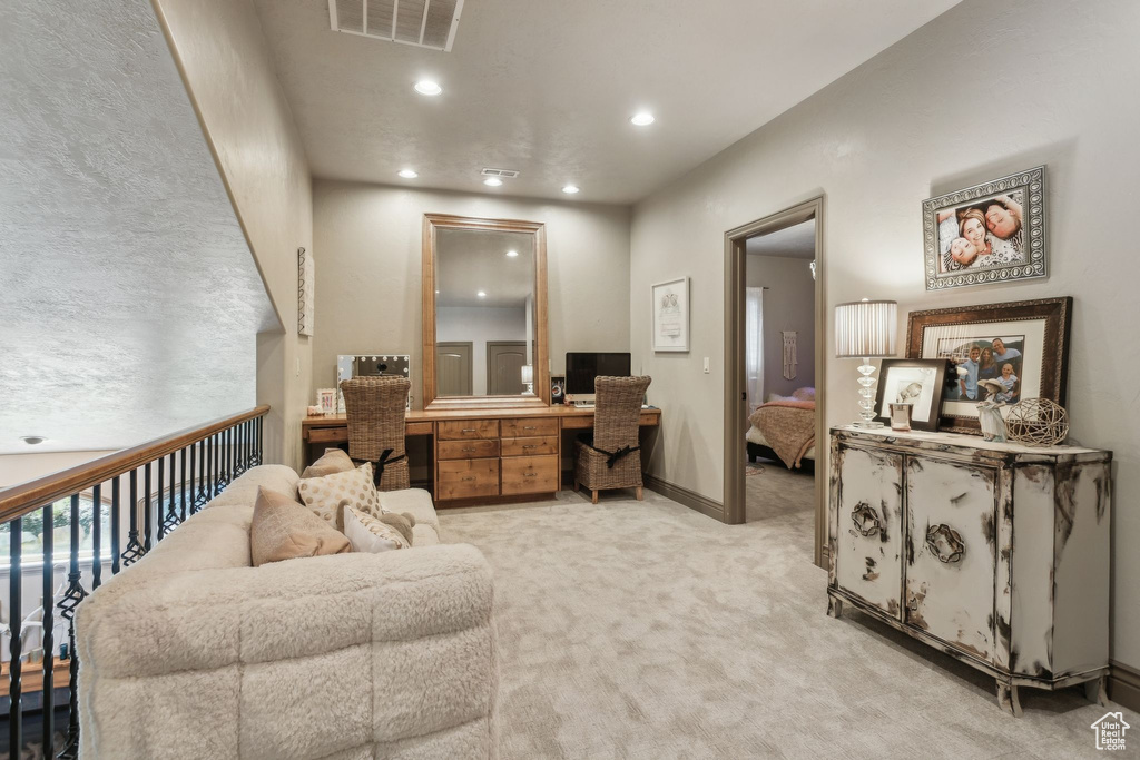 Office area featuring light carpet, recessed lighting, baseboards, and built in desk