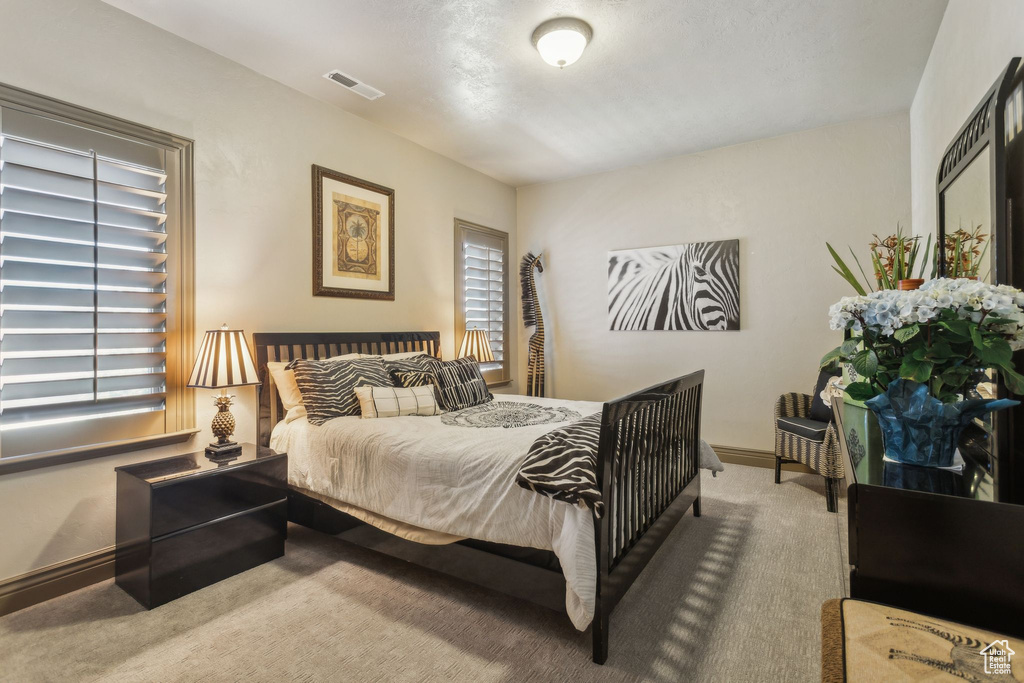 Bedroom with carpet flooring and baseboards