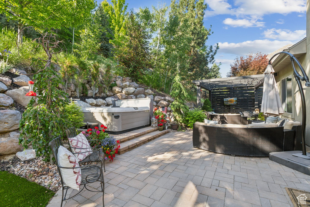 View of patio / terrace featuring outdoor lounge area and a hot tub