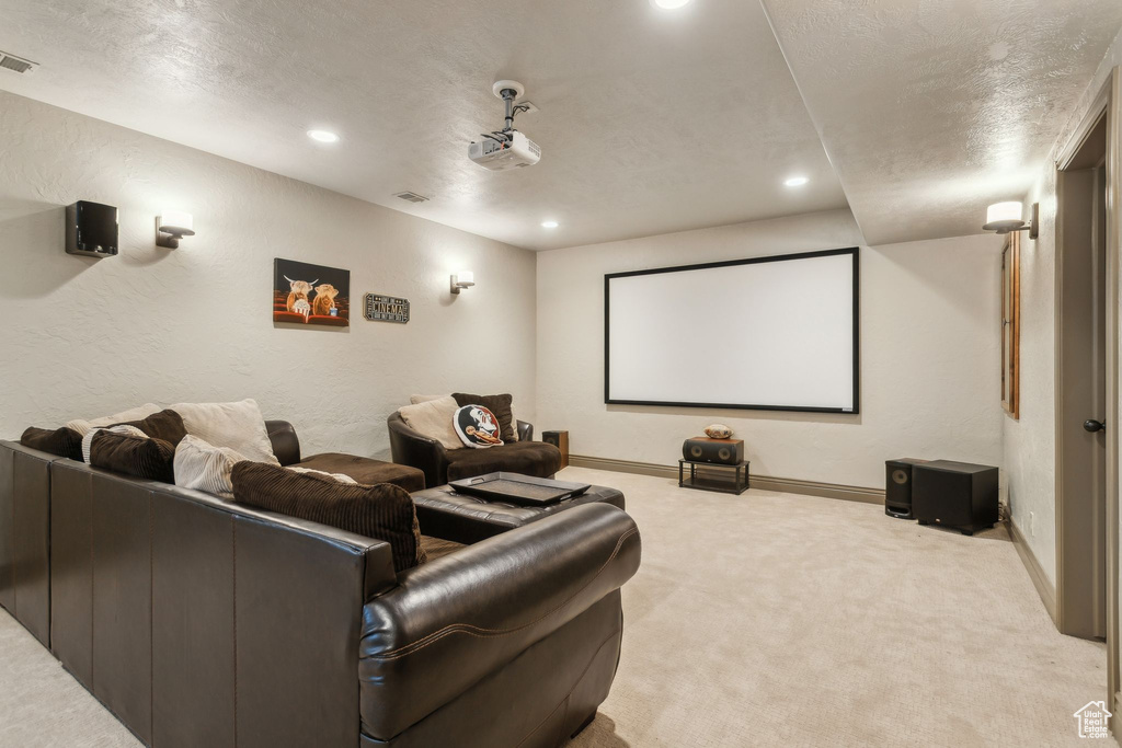 Carpeted cinema room featuring recessed lighting, baseboards, a textured wall, and a textured ceiling