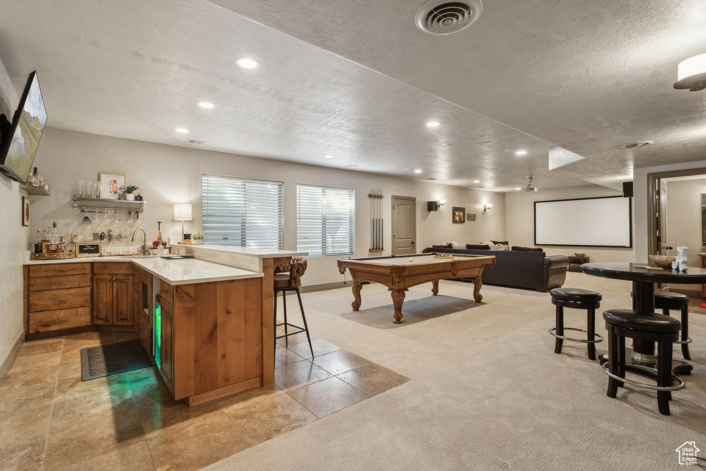 Rec room featuring wet bar, recessed lighting, light carpet, a textured ceiling, and billiards