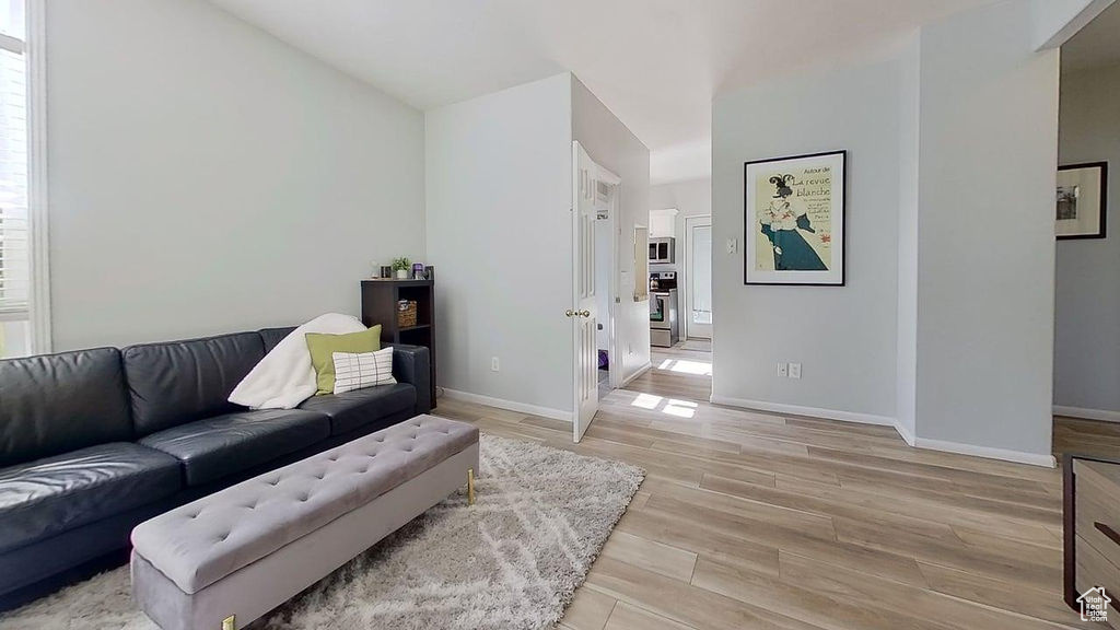 Living area featuring light wood-type flooring and baseboards