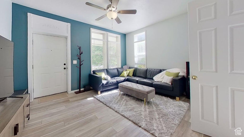 Living area featuring a ceiling fan and light wood-style floors