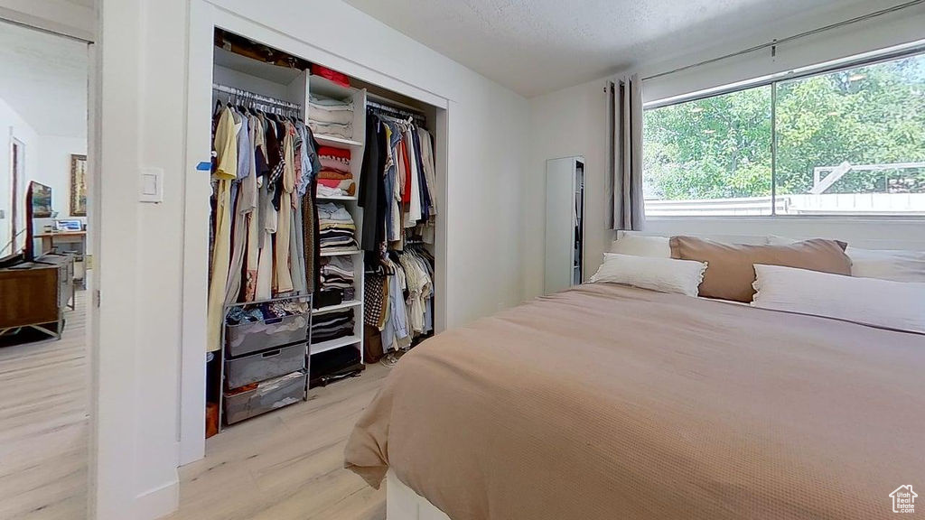 Bedroom featuring a closet and light wood-style floors
