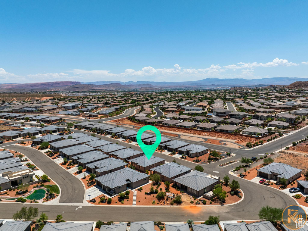 Aerial perspective of suburban area featuring a mountainous background