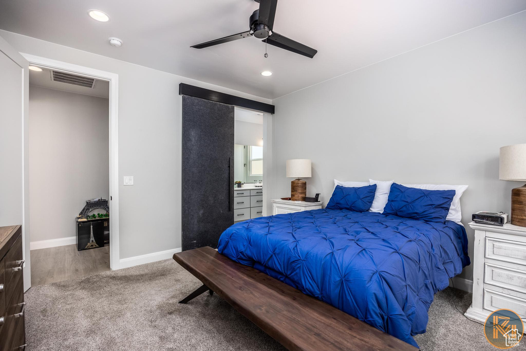 Carpeted bedroom with baseboards, recessed lighting, a ceiling fan, and connected bathroom