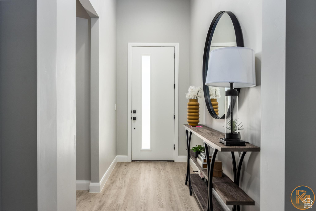 Foyer entrance featuring wood finished floors and baseboards