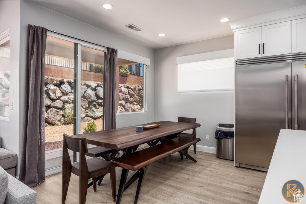 Dining area with light wood-type flooring, recessed lighting, and baseboards