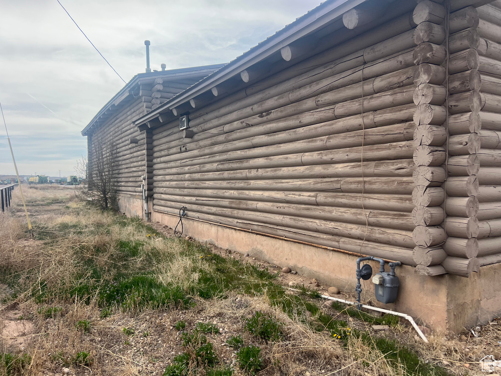 View of property exterior featuring log exterior