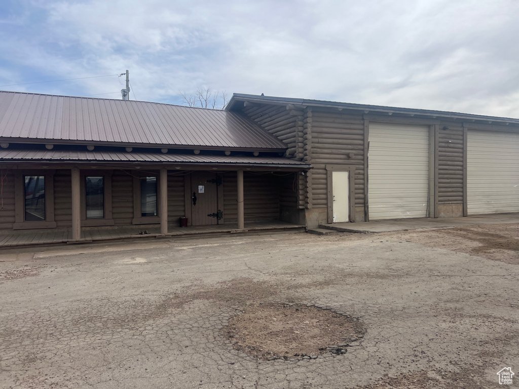View of building exterior featuring an attached garage and driveway