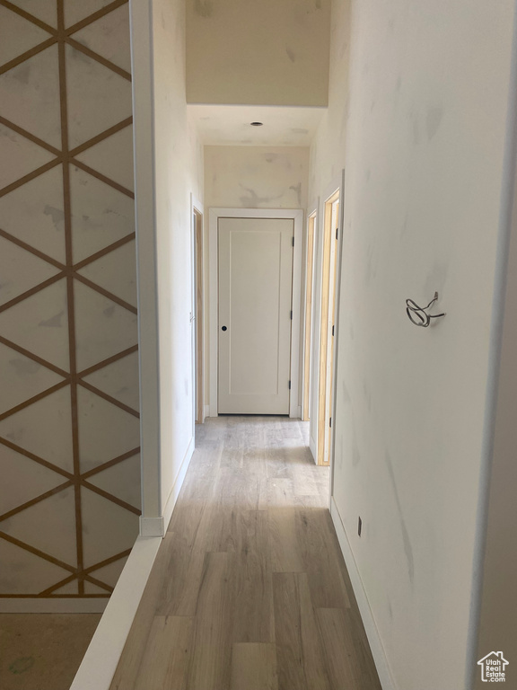 Corridor featuring wood finished floors and baseboards