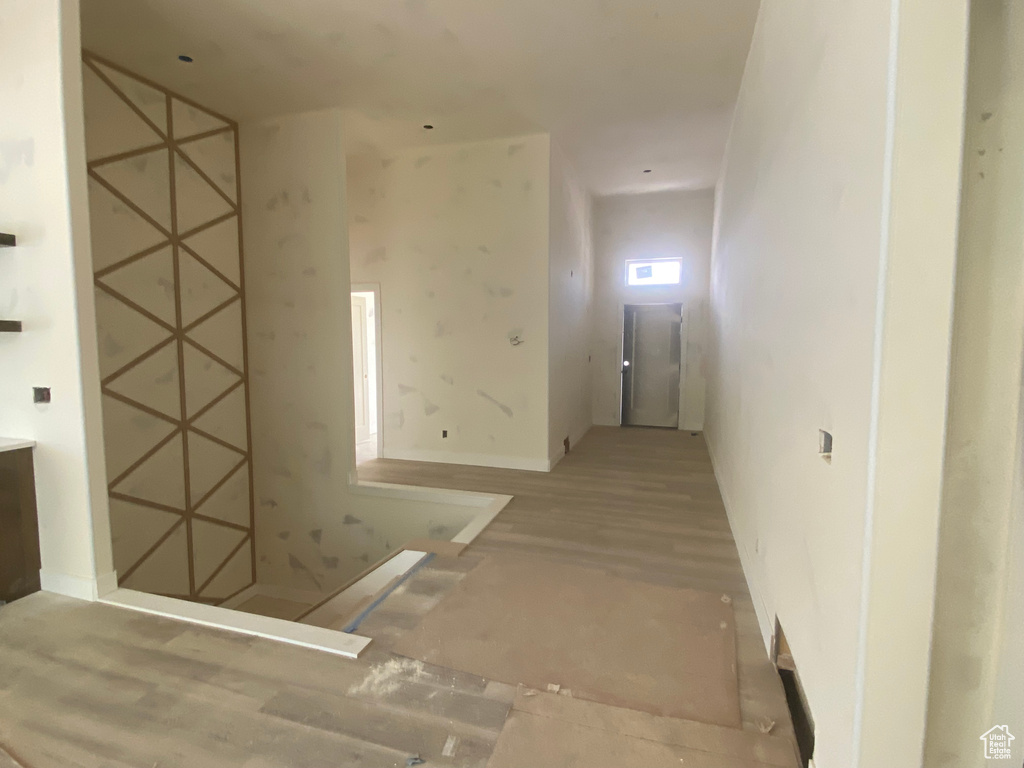 Hallway with wood finished floors and baseboards