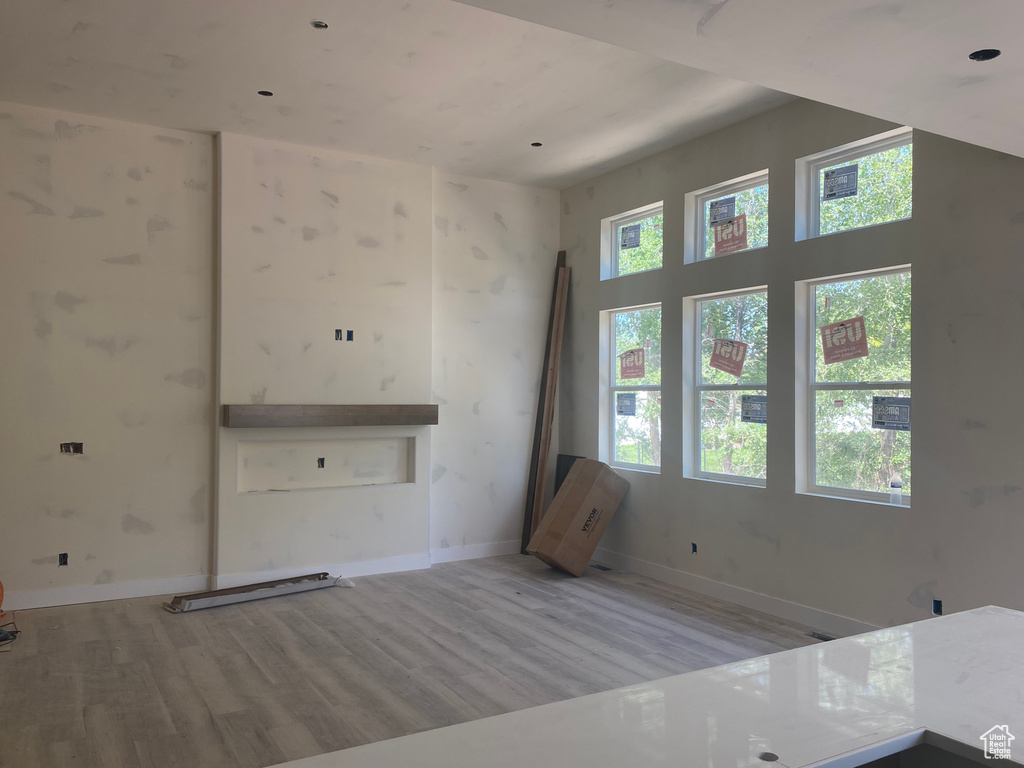 Unfurnished living room with wood finished floors and baseboards