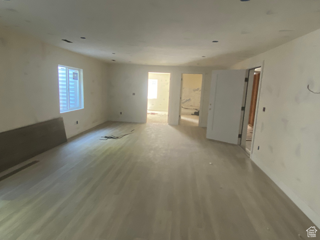 Unfurnished room featuring light wood finished floors and baseboards