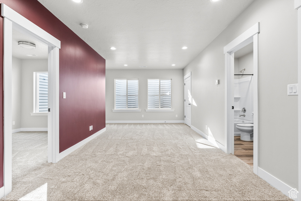 Spare room featuring carpet floors, baseboards, recessed lighting, and a smoke detector