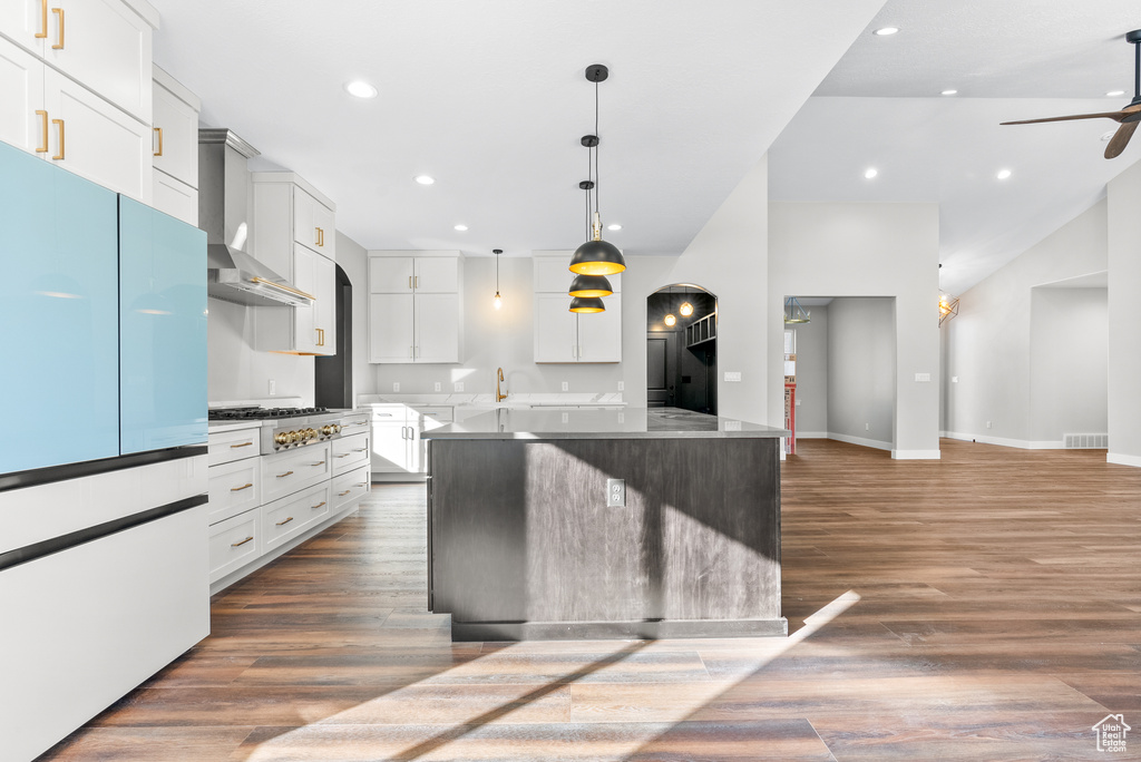 Kitchen with white fridge, ceiling fan, a center island, dark wood-style floors, and recessed lighting