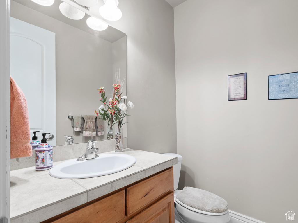Half bathroom with vanity and toilet