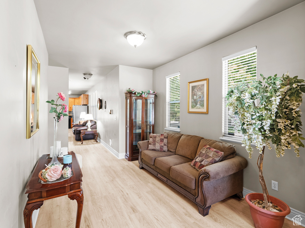 Living room with light wood-style floors and baseboards