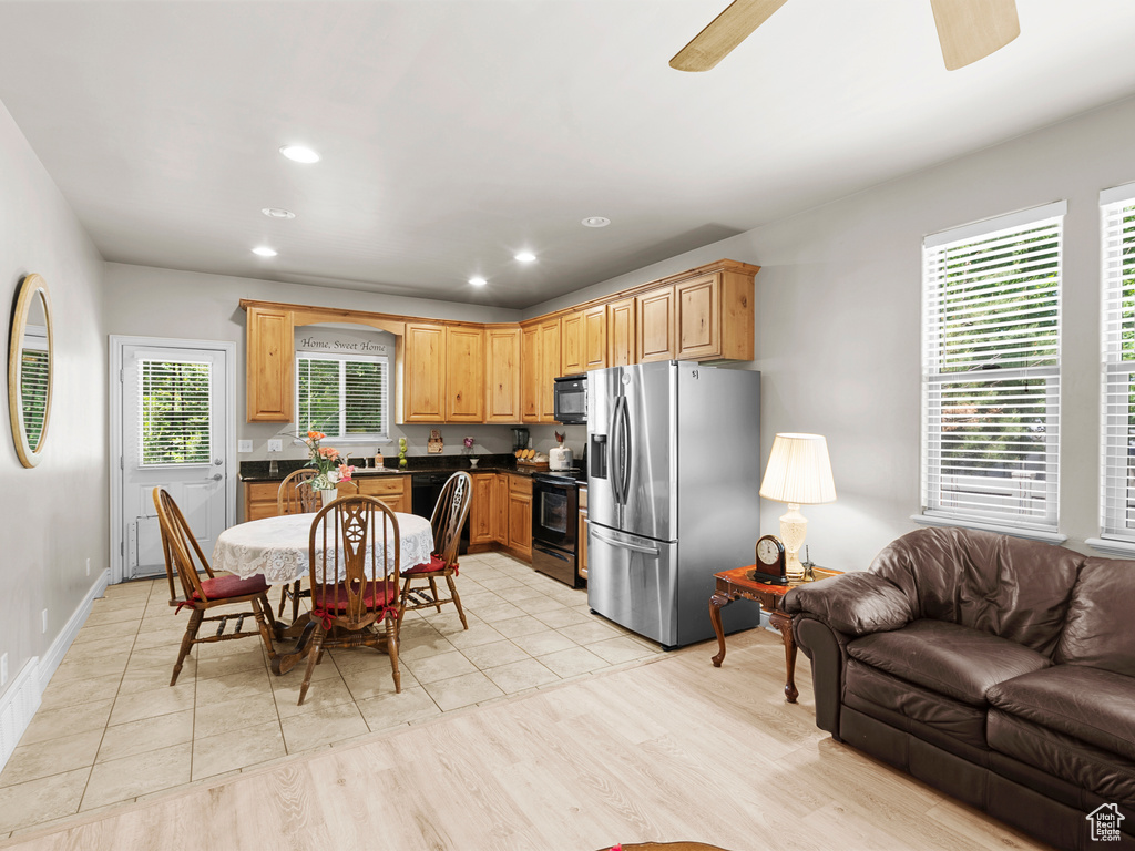 Kitchen featuring black appliances, a ceiling fan, dark countertops, open floor plan, and recessed lighting