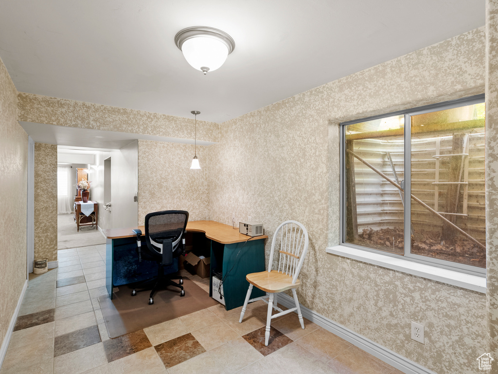 Home office featuring baseboards, wallpapered walls, and light tile patterned floors