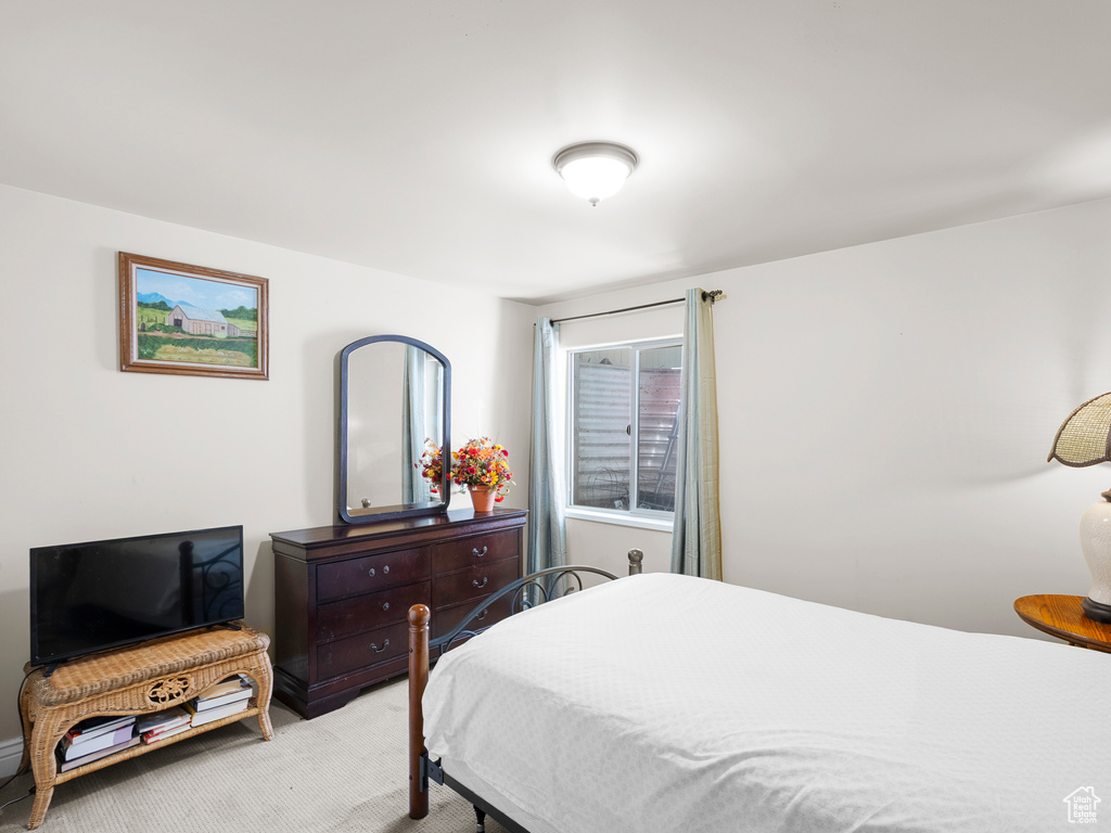 Bedroom with light colored carpet
