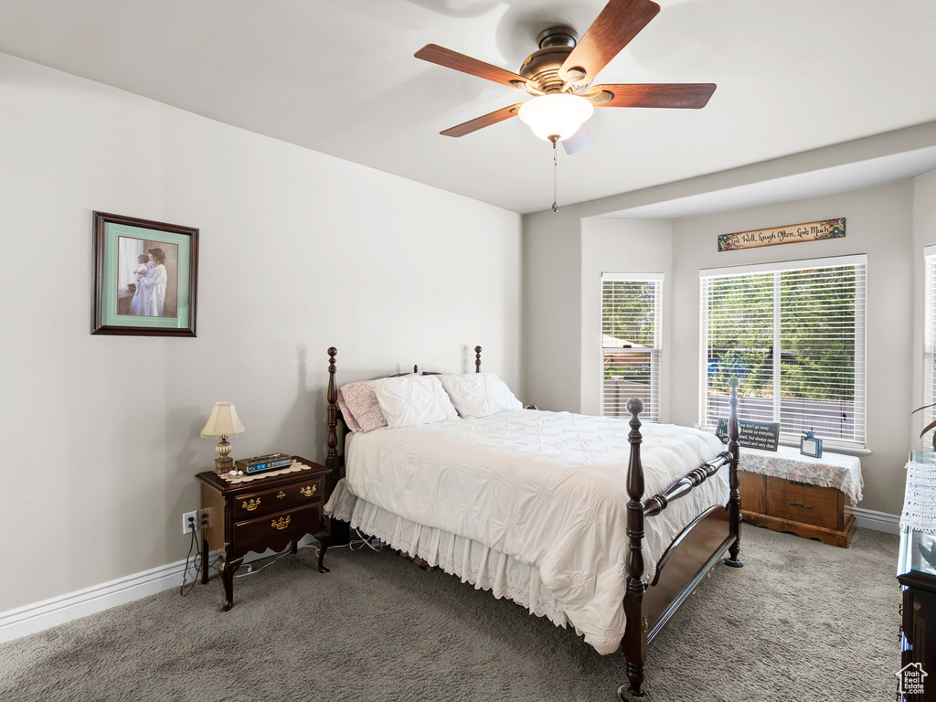 Carpeted bedroom with baseboards and ceiling fan