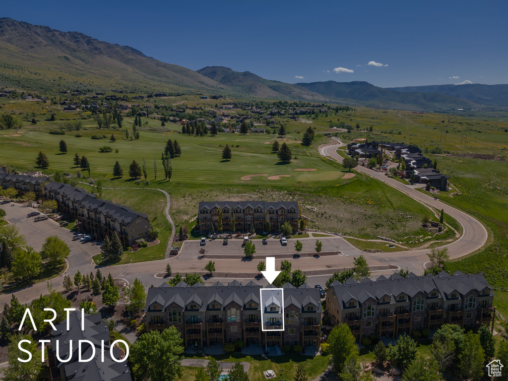 Aerial view of a mountainous background and a golf course