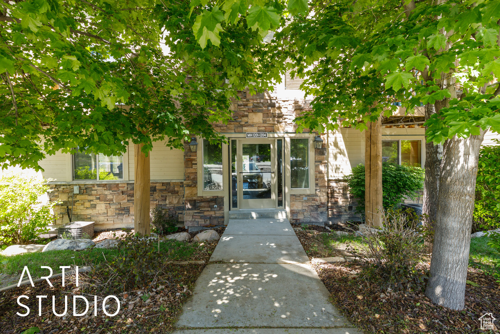 View of exterior entry featuring stone siding