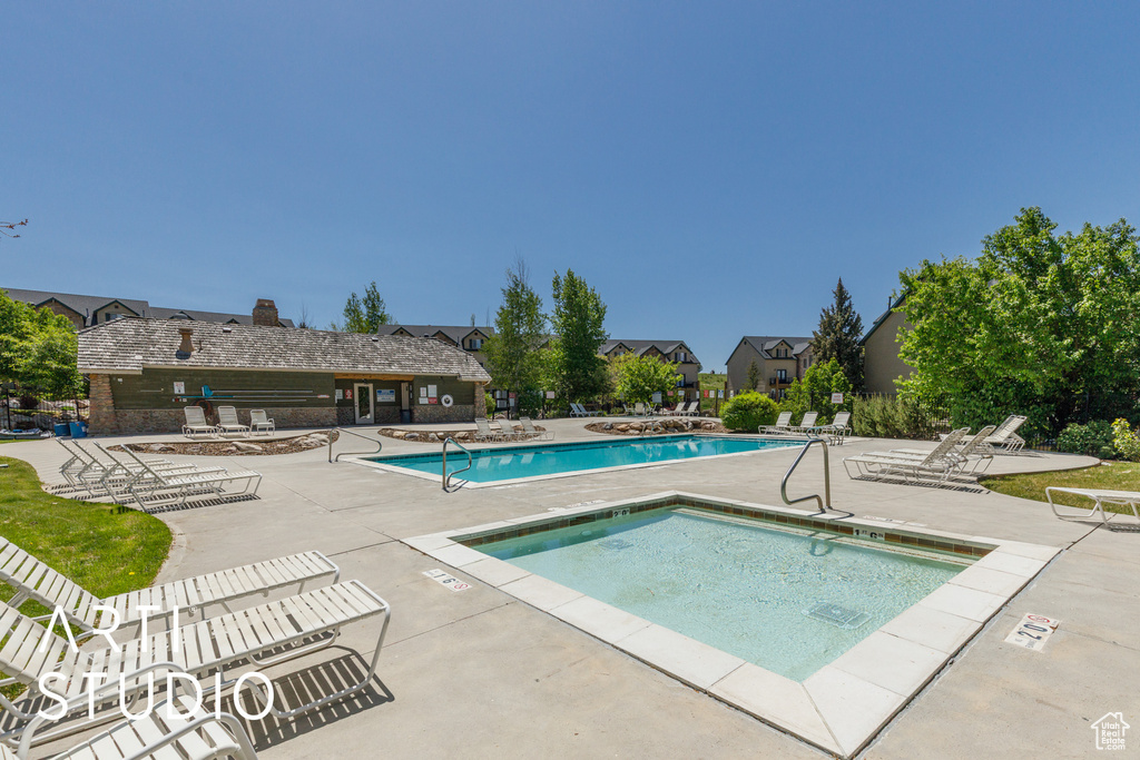 Community pool featuring a patio