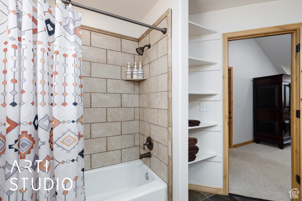 Bathroom with shower / bathtub combination with curtain and baseboards