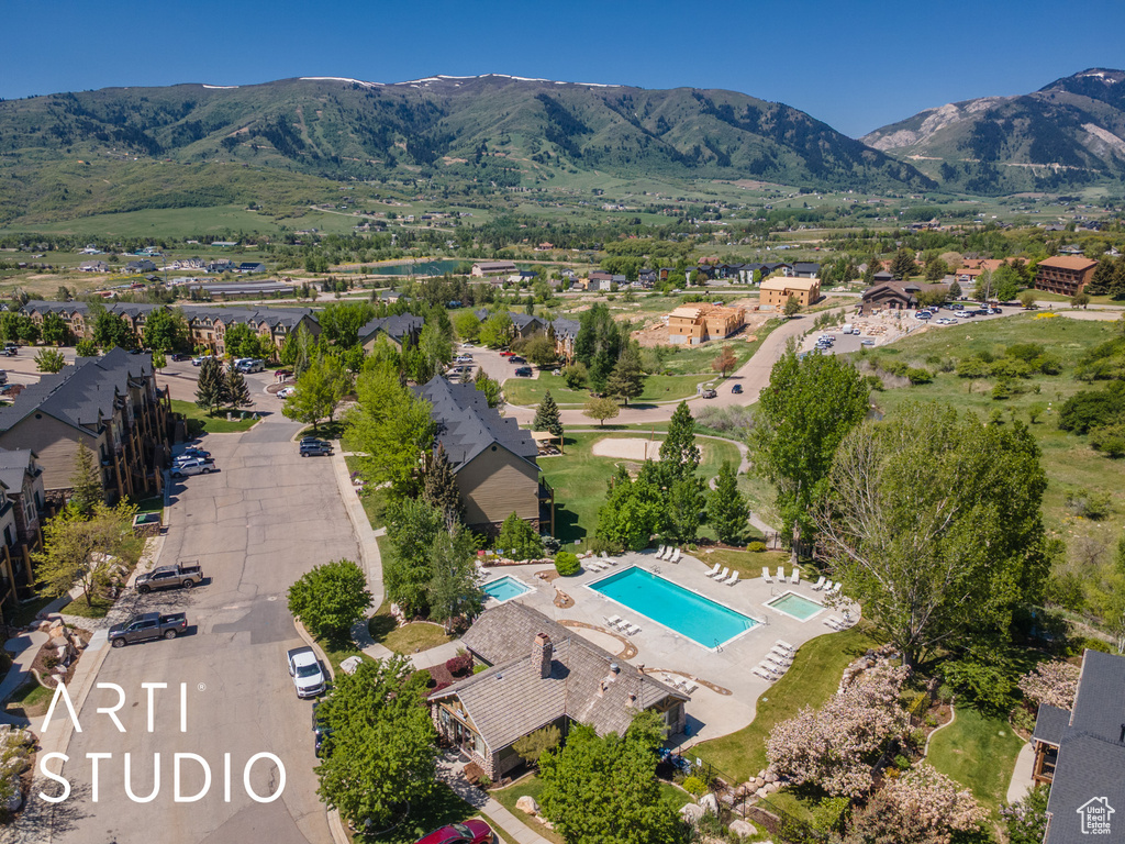 Drone / aerial view of a pool area and a mountain backdrop