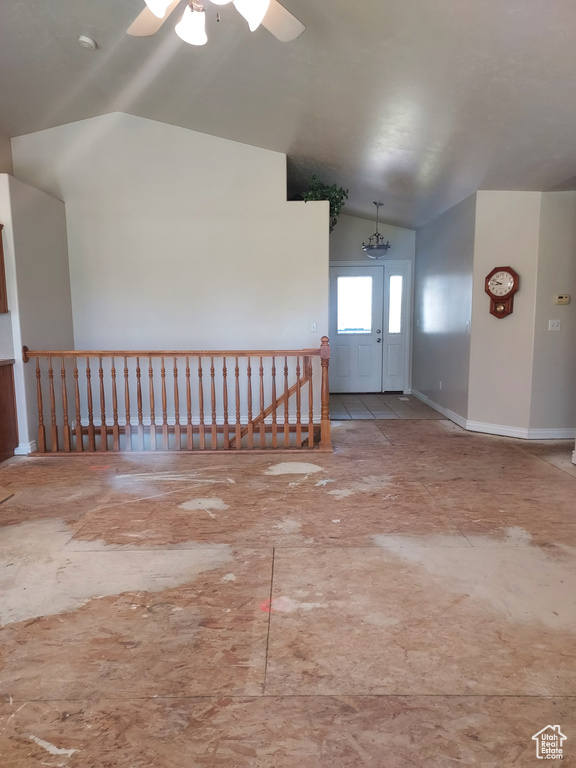 Empty room featuring lofted ceiling and a ceiling fan