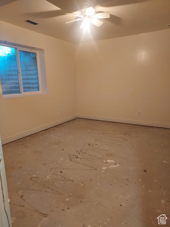 Unfurnished room with a ceiling fan and baseboards