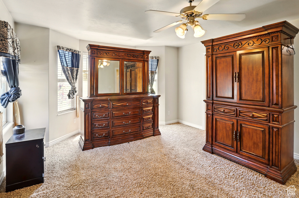 Bedroom featuring carpet floors, baseboards, and ceiling fan