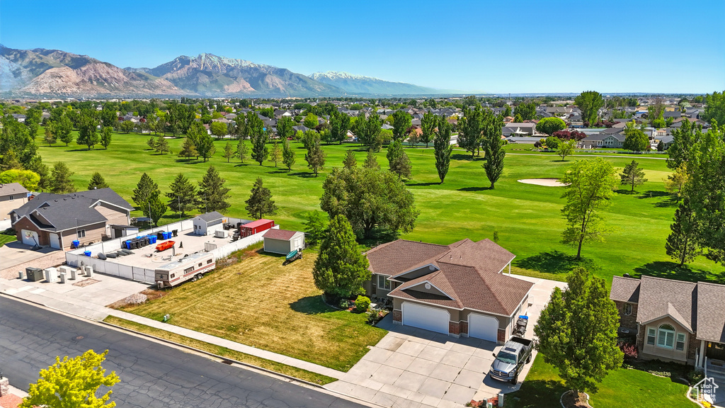 Aerial perspective of suburban area featuring mountains and a local golf course