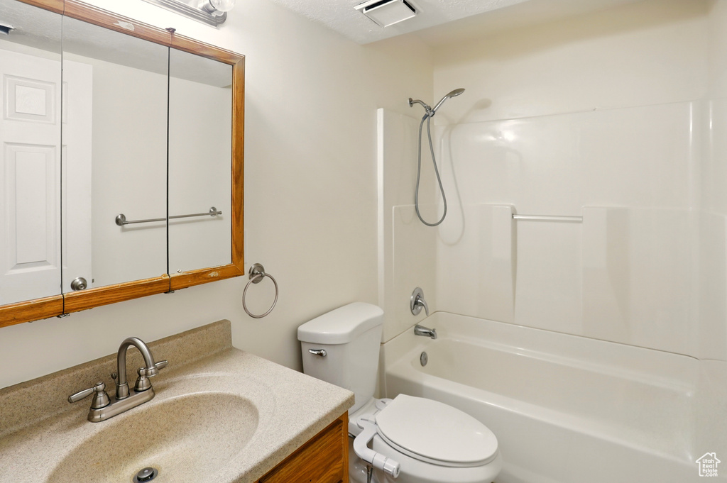 Full bath featuring tub / shower combination, vanity, and toilet