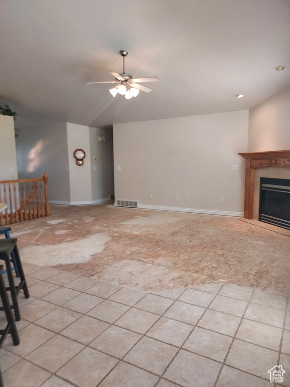 Unfurnished living room featuring vaulted ceiling, ceiling fan, a fireplace, and recessed lighting