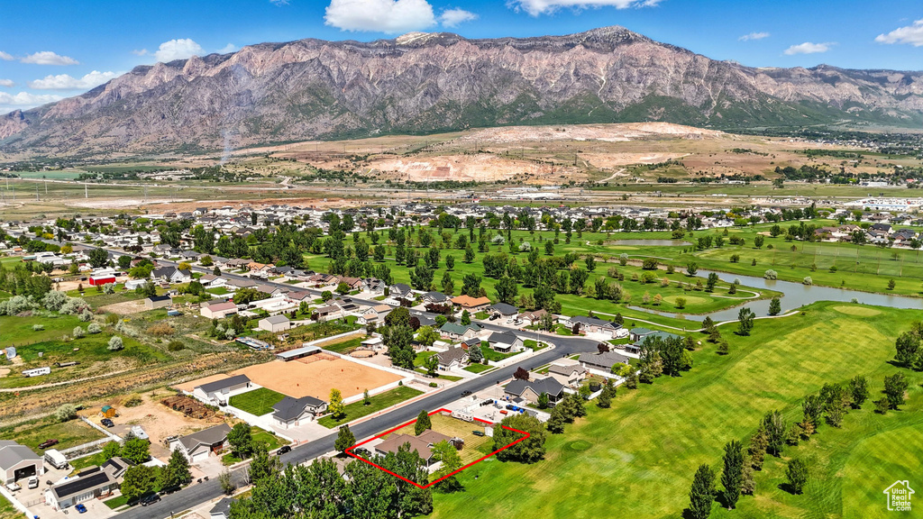 Aerial view of residential area featuring property boundaries highlighted and a water and mountain view