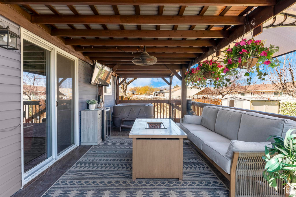 Deck with an outdoor living space with a fire pit