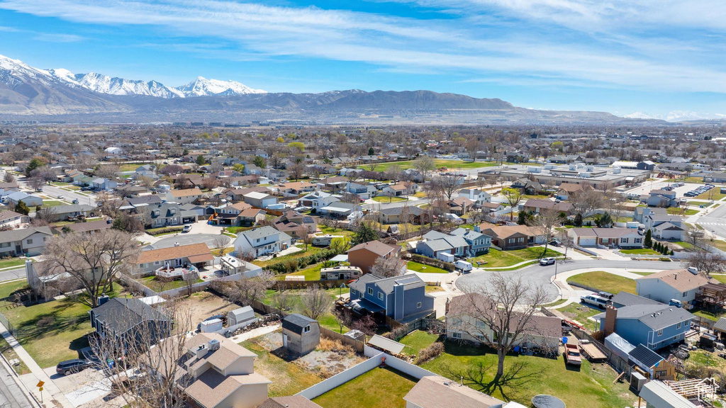 Aerial perspective of suburban area featuring a mountainous background