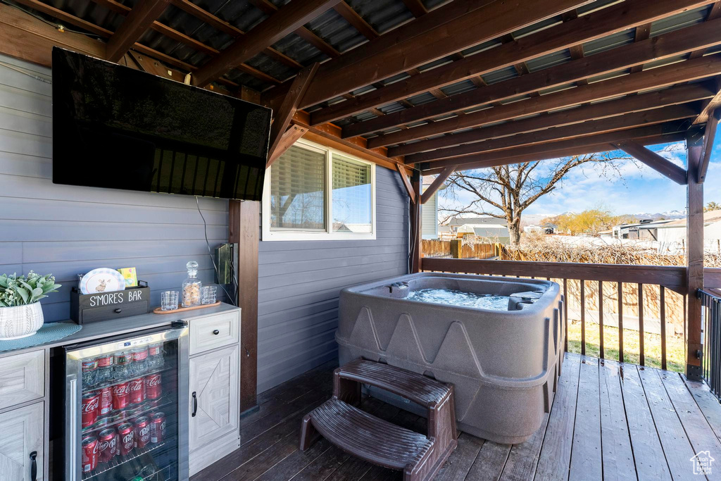 Wooden terrace featuring beverage cooler