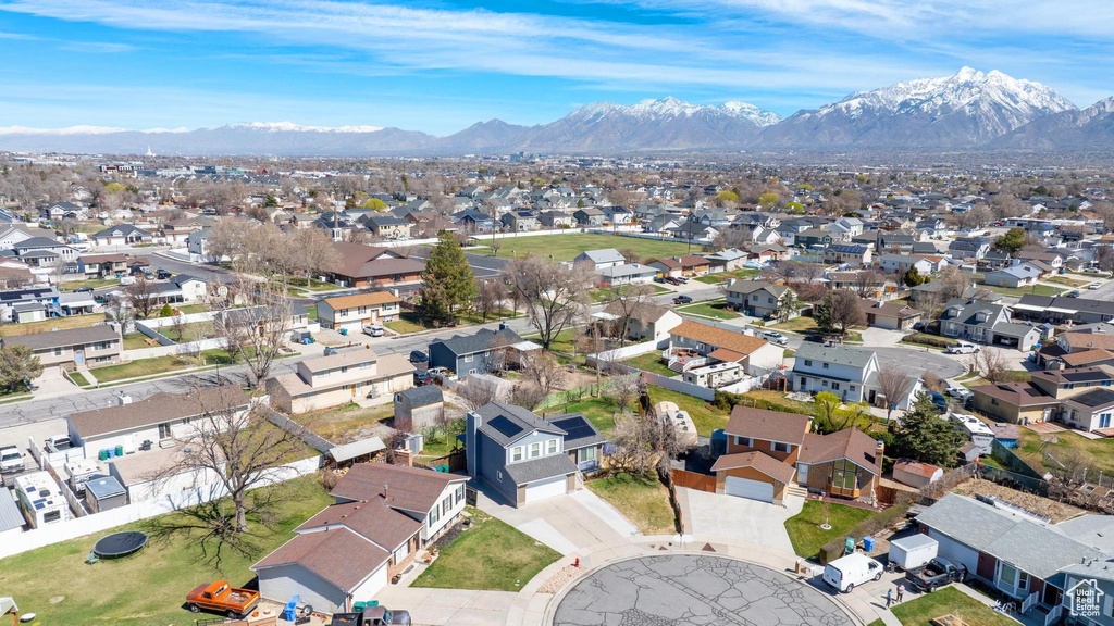 Aerial view of property's location with a mountainous background and nearby suburban area
