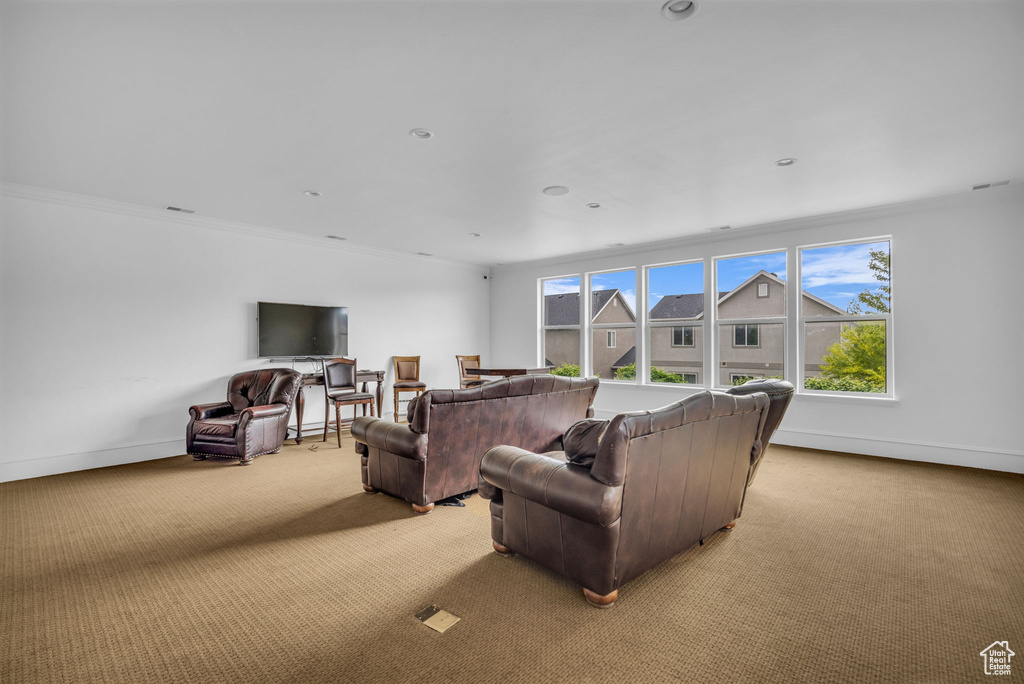 Living room with light colored carpet, baseboards, crown molding, and recessed lighting
