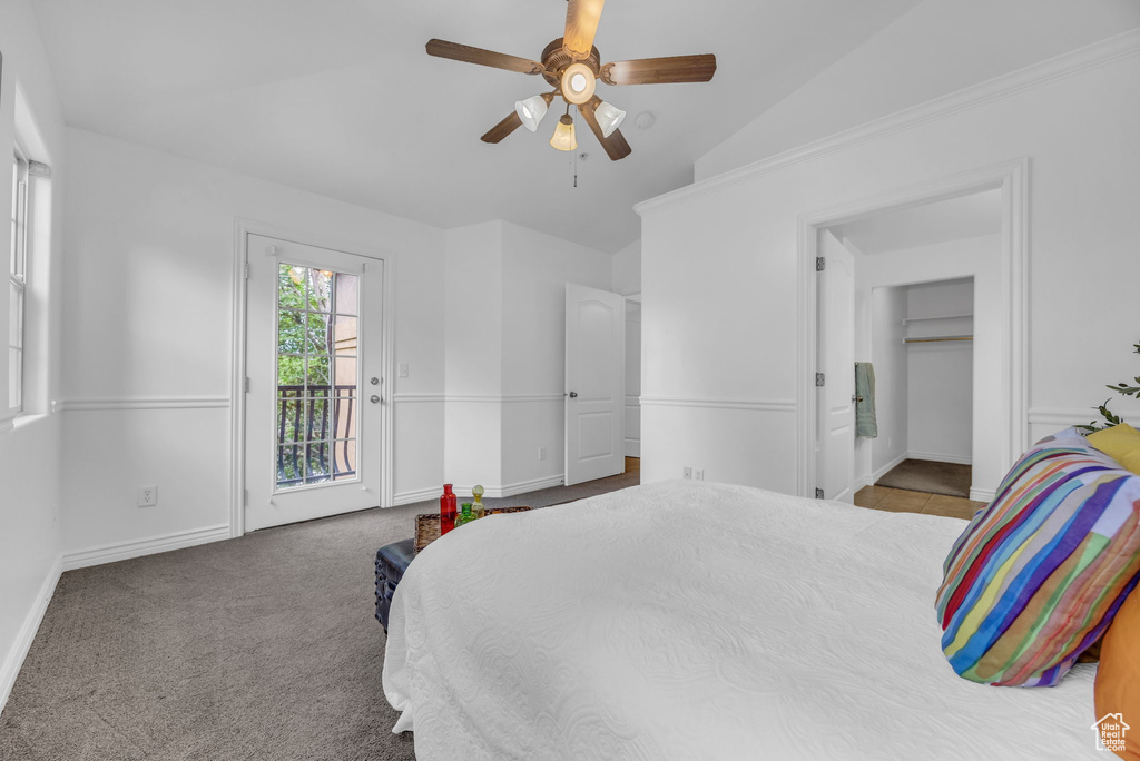Bedroom featuring access to outside, vaulted ceiling, baseboards, ceiling fan, and carpet floors