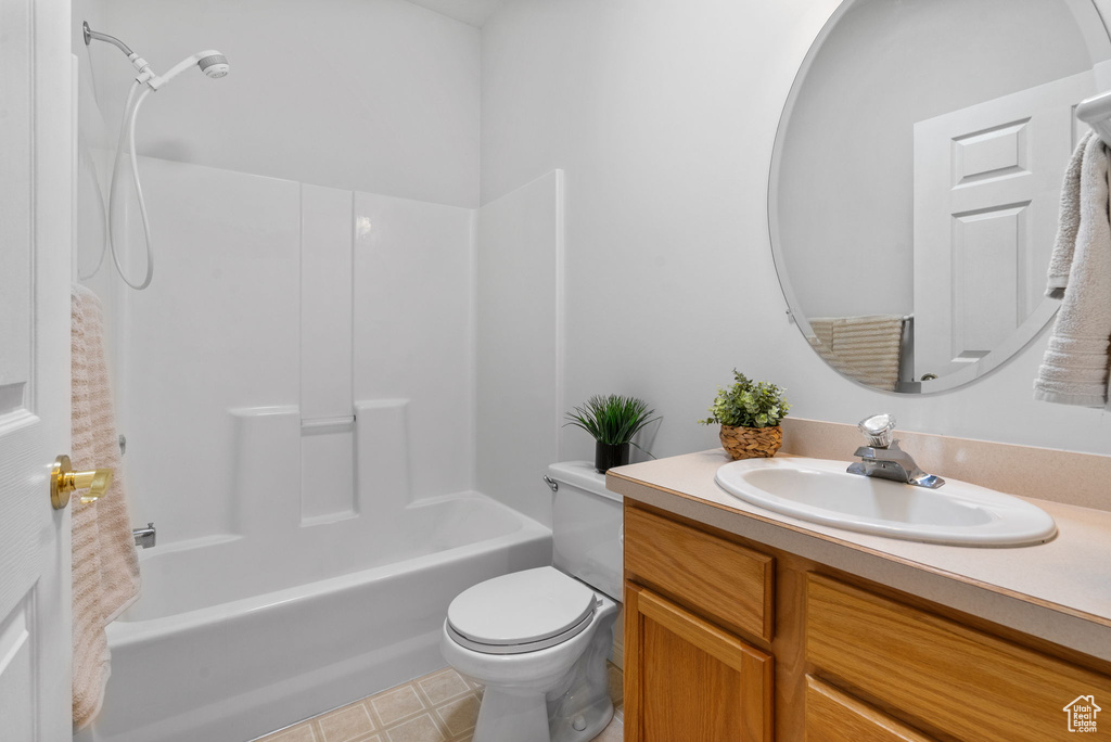 Bathroom with vanity, toilet, and shower / bathtub combination