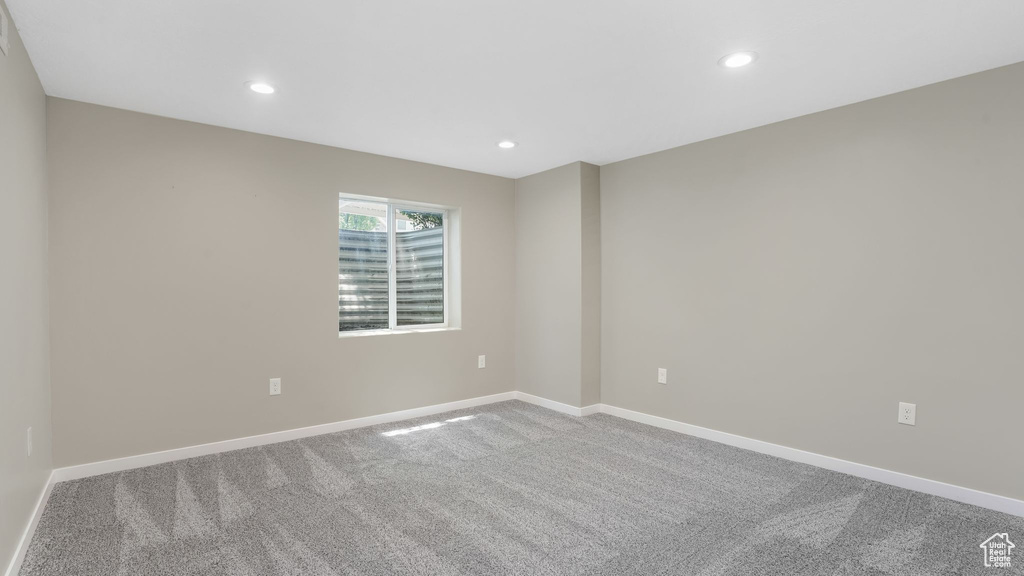 Spare room with carpet floors, recessed lighting, and baseboards
