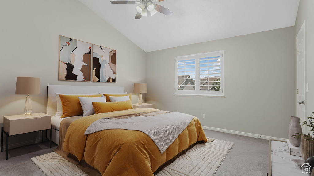 Carpeted bedroom with lofted ceiling, baseboards, and ceiling fan