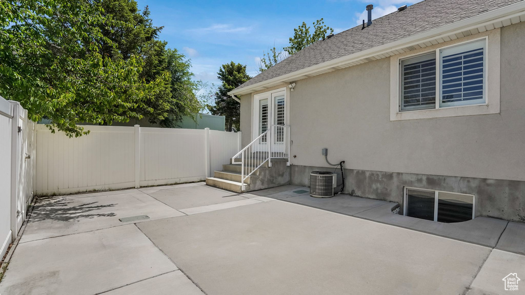 View of patio with entry steps and cooling unit