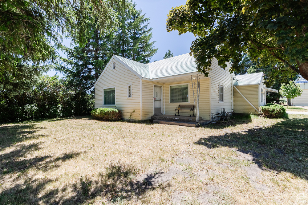 View of front of house with a porch and a front lawn