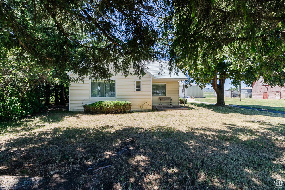 Back of house with a yard